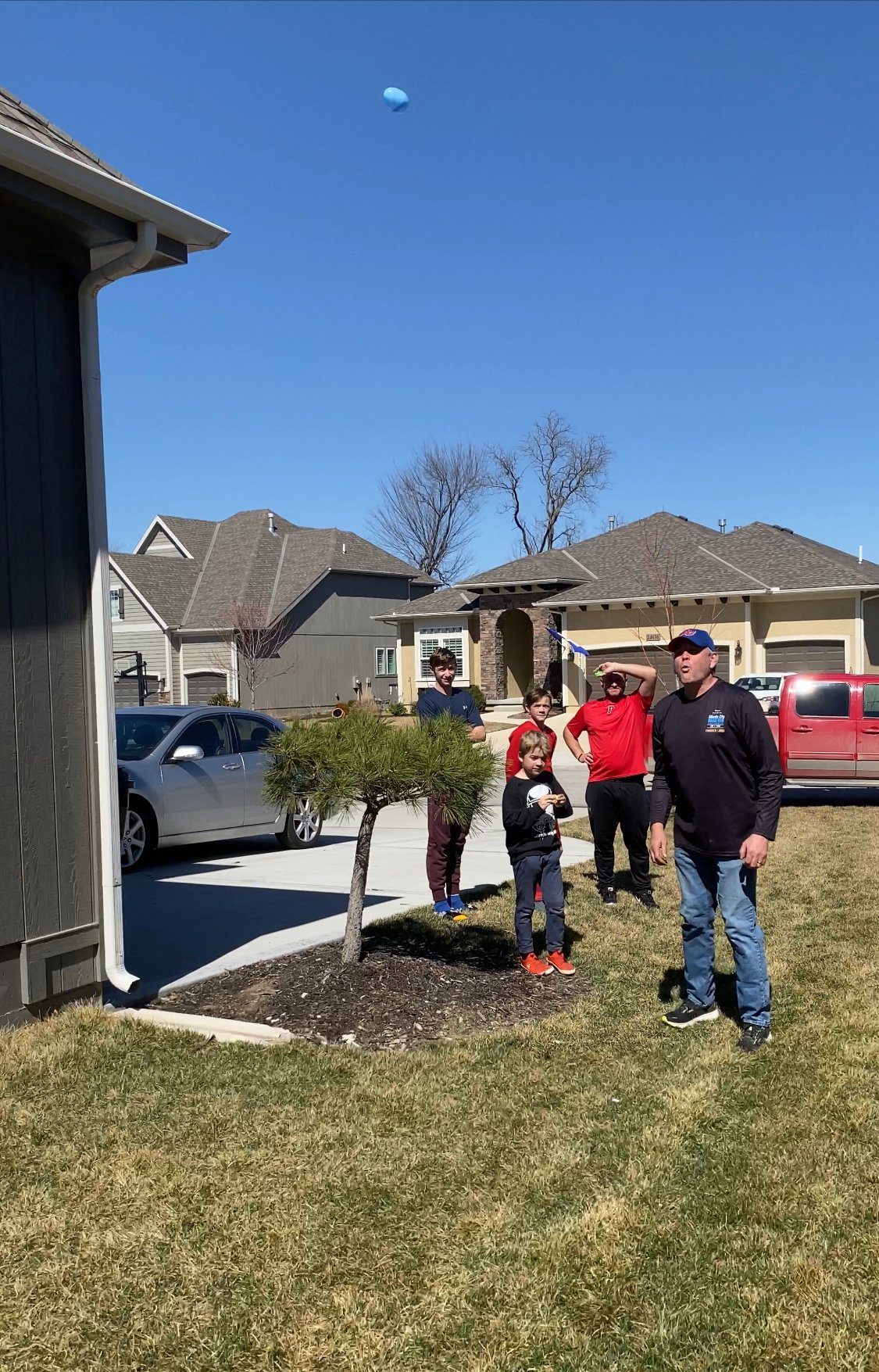 man spitting an Easter egg across the yard