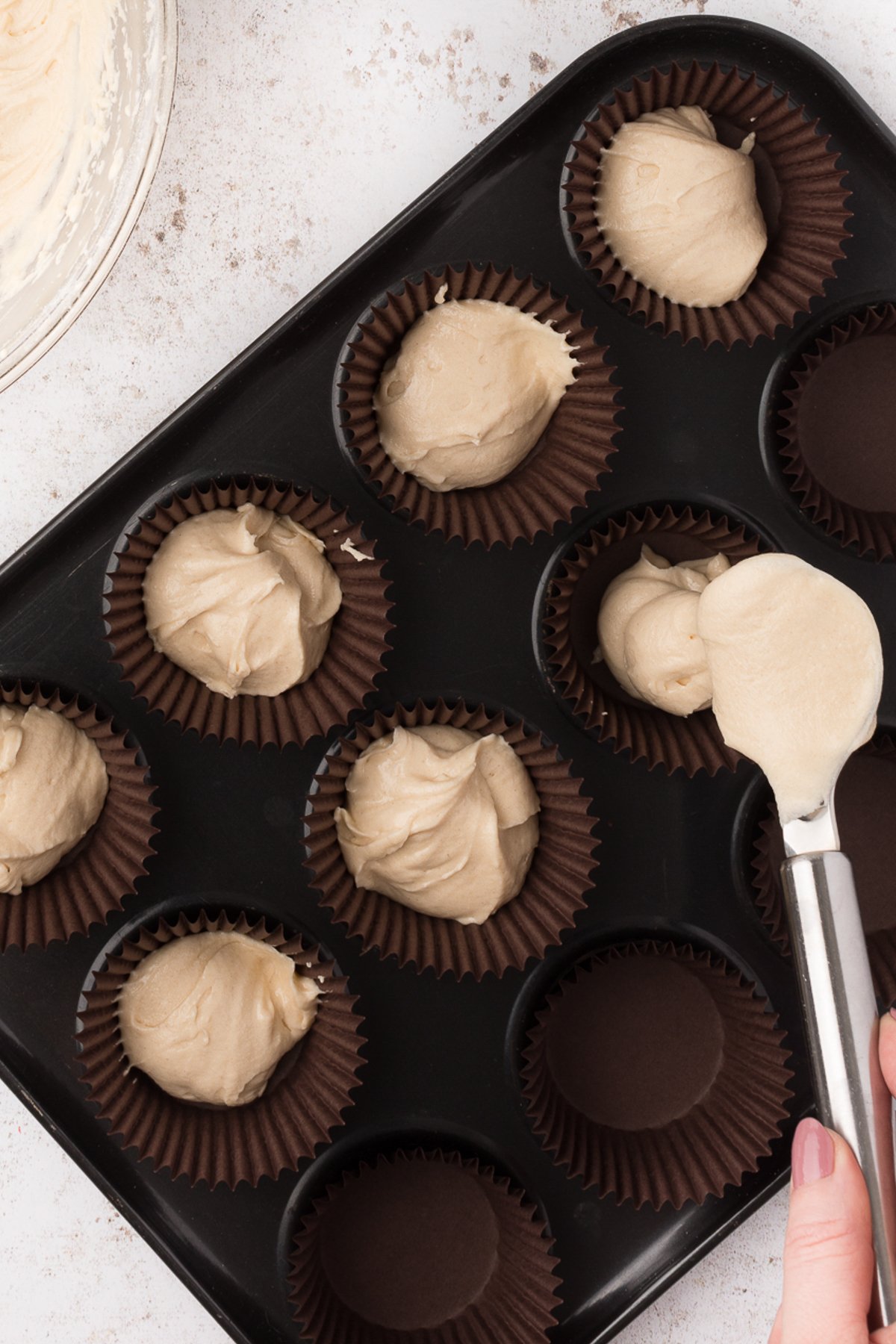 cupcake tins with vanilla cupcake batter inside