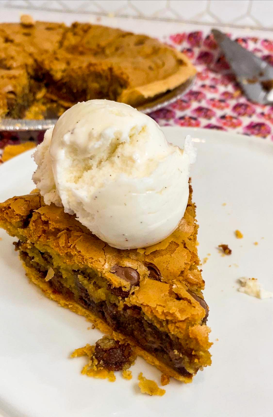 slice of chocolate chip cookie pie with ice cream on top