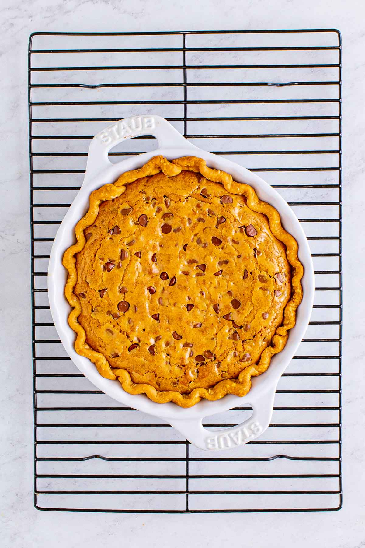 baked chocolate chip cookie pie on a wire cooling rack