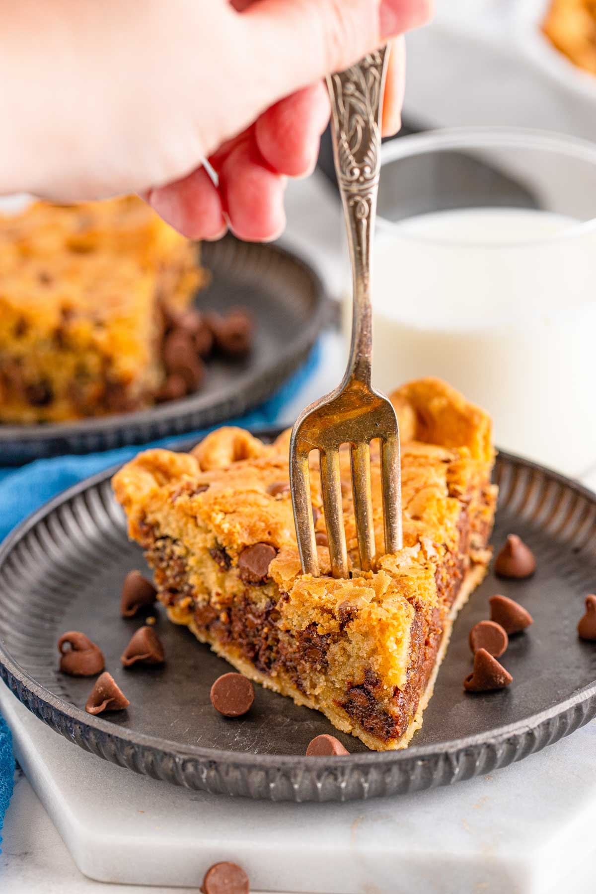 fork taking a bite of a chocolate chip cookie pie slice