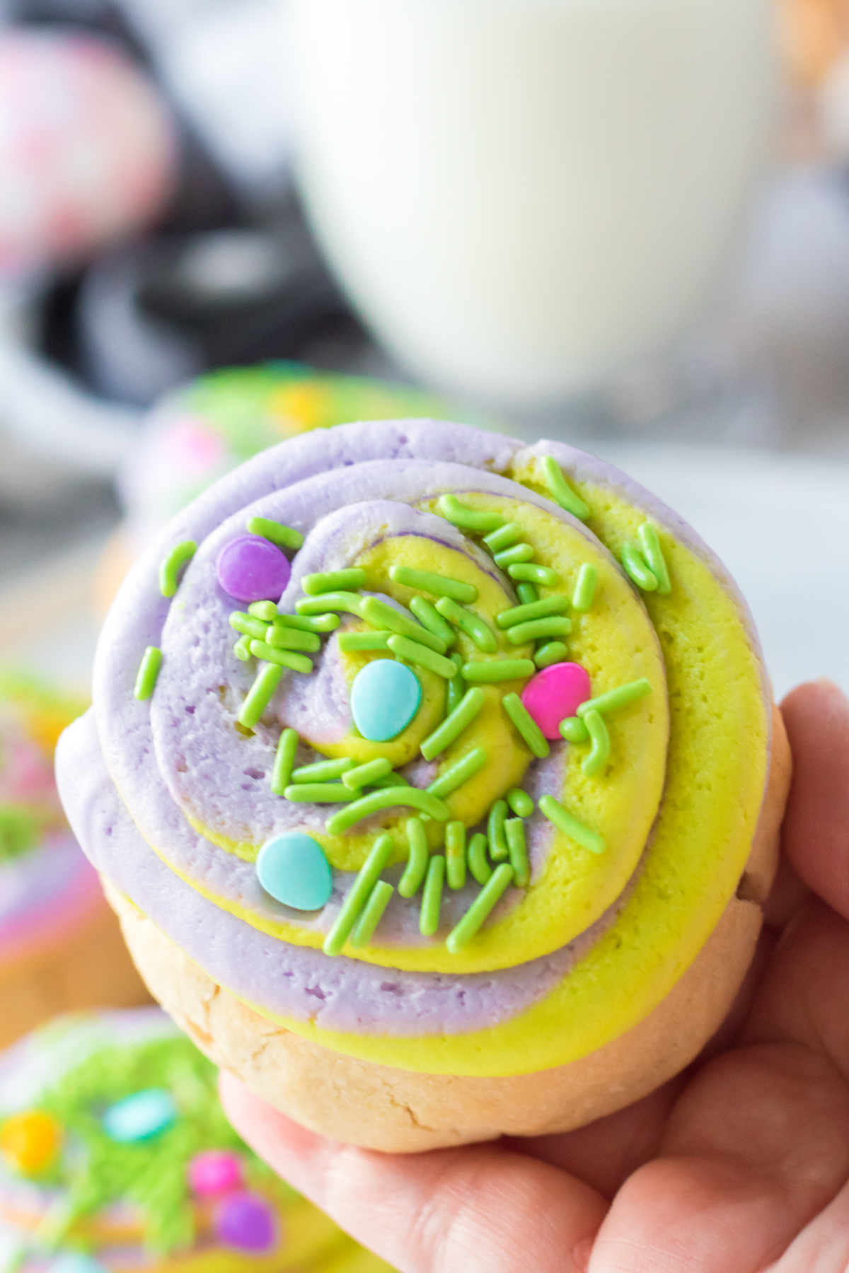 hand holding an Easter cookie with swirled frosting