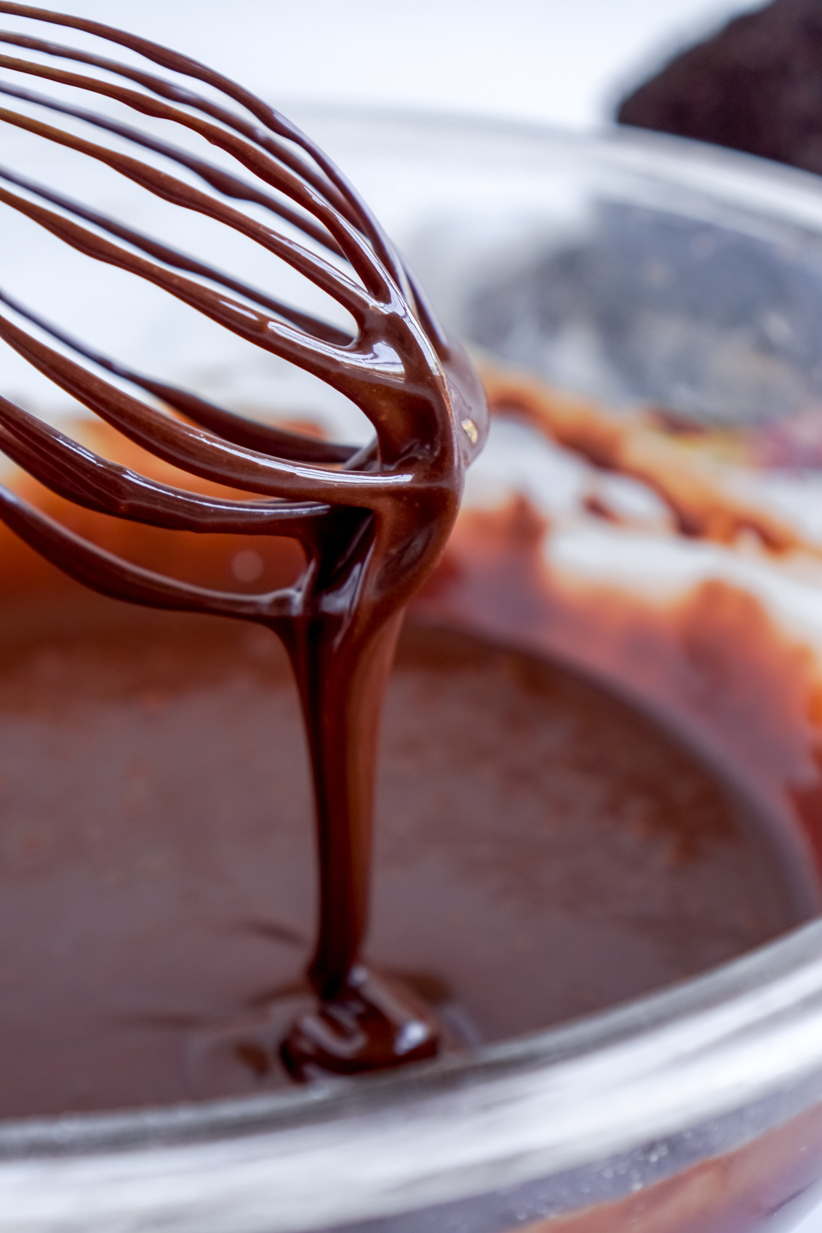 whisk with a thick chocolate glaze running off