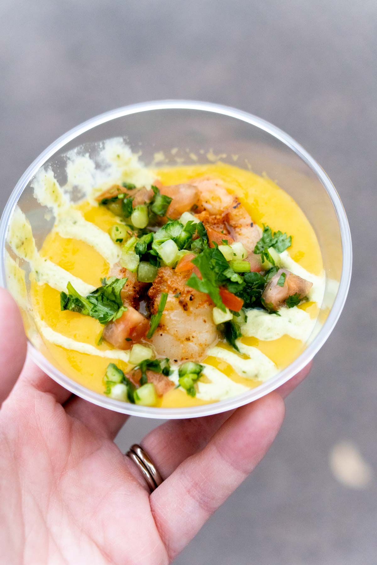 hand holding carrot gazpacho at Disneyland food and wine festival