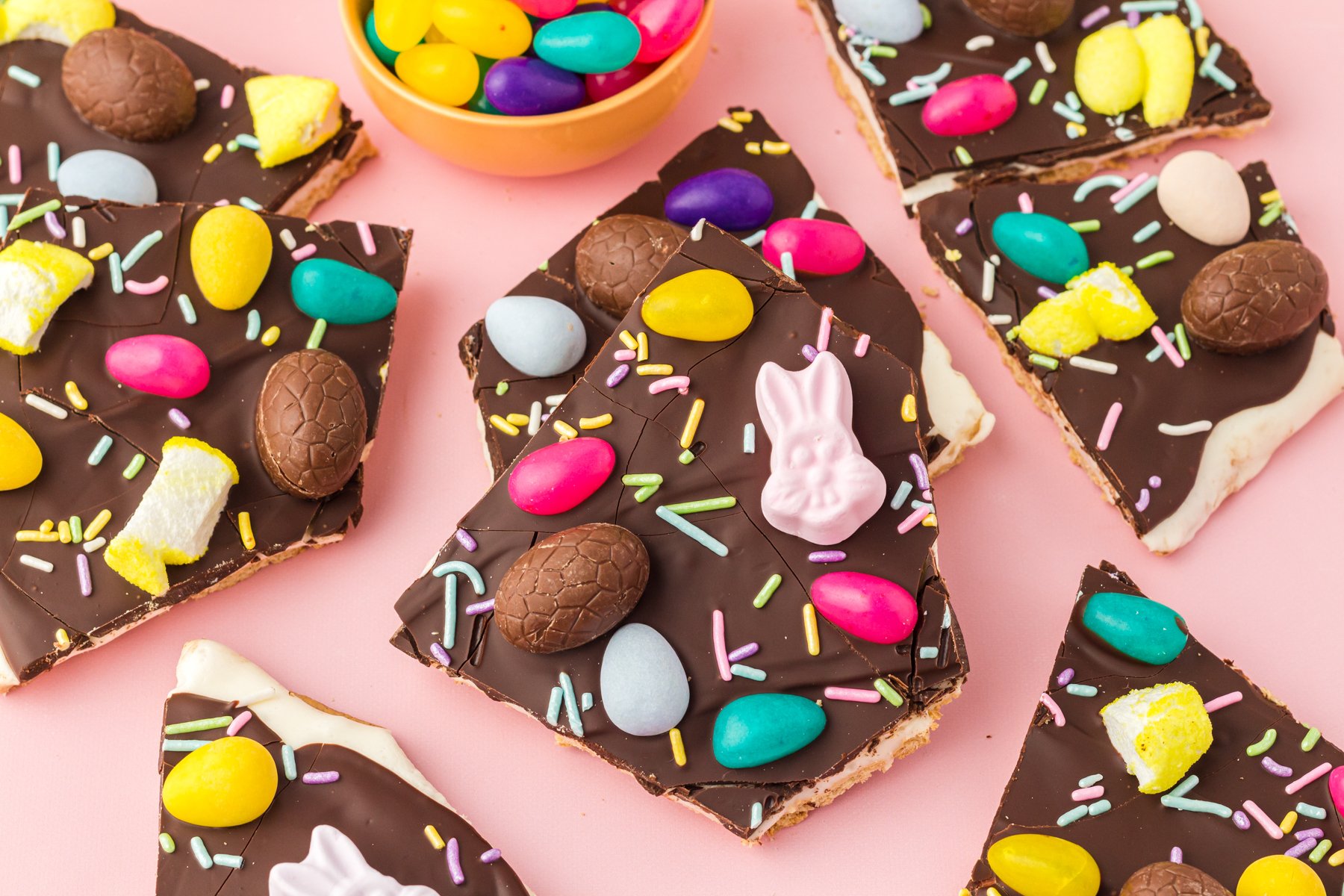 pieces of Easter chocolate bark on a pink background