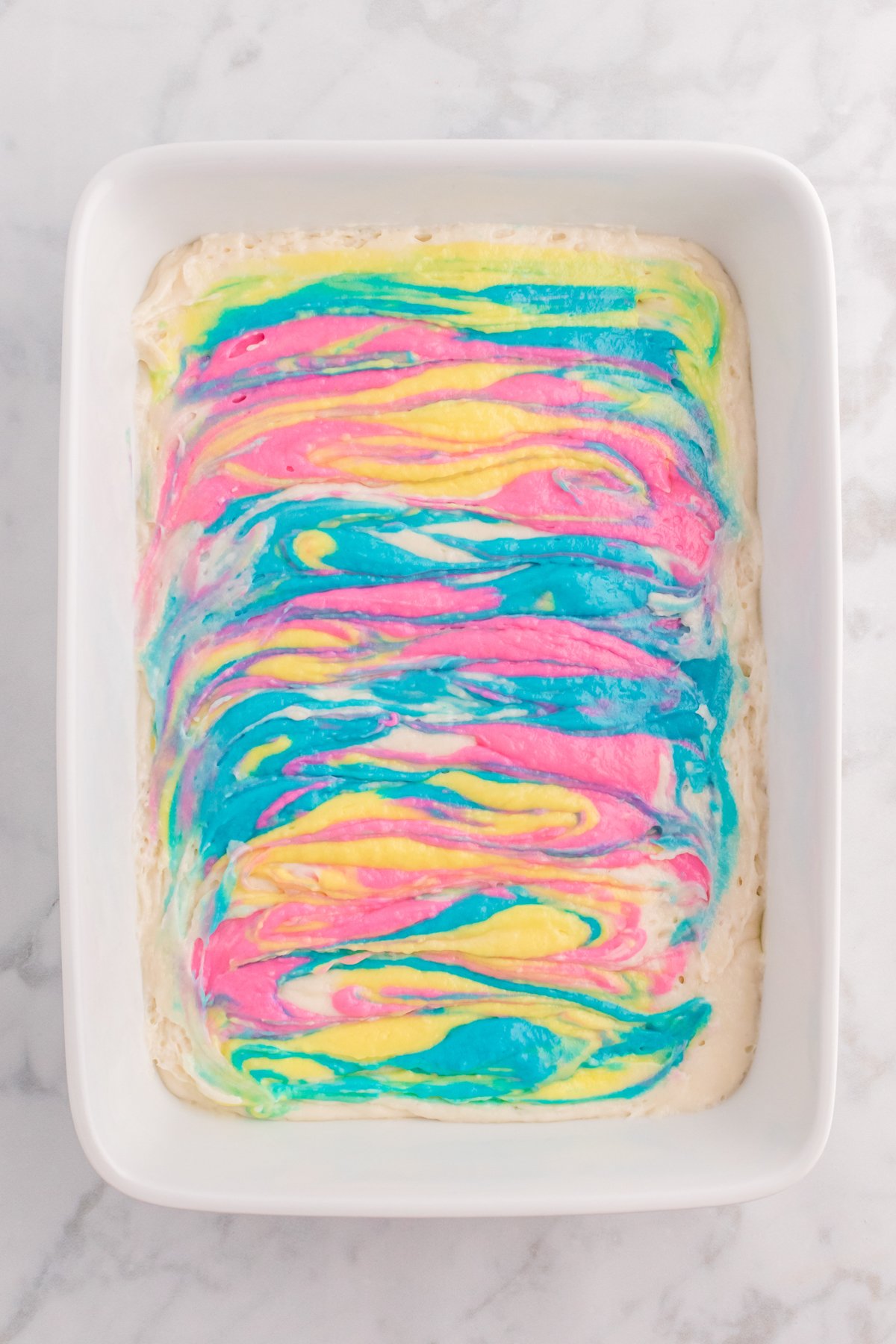 white cake pan with a swirled Easter cake inside