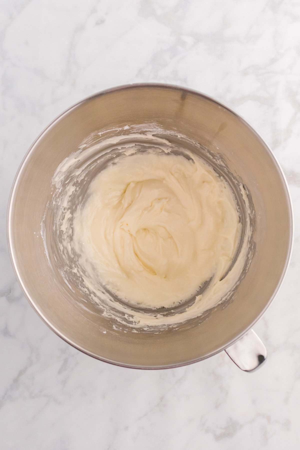 metal bowl with buttercream frosting