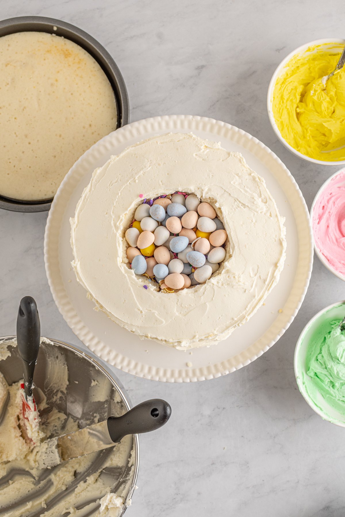 white cake with a hole filled with Cadbury eggs