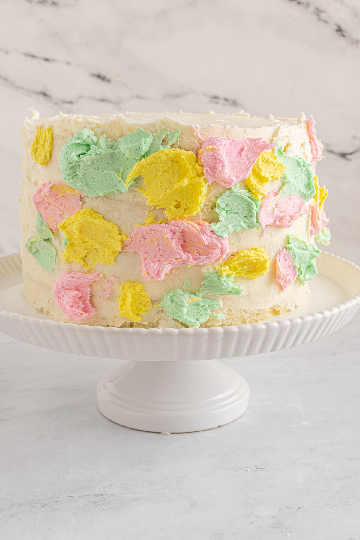 white cake with pastel frosting splotches