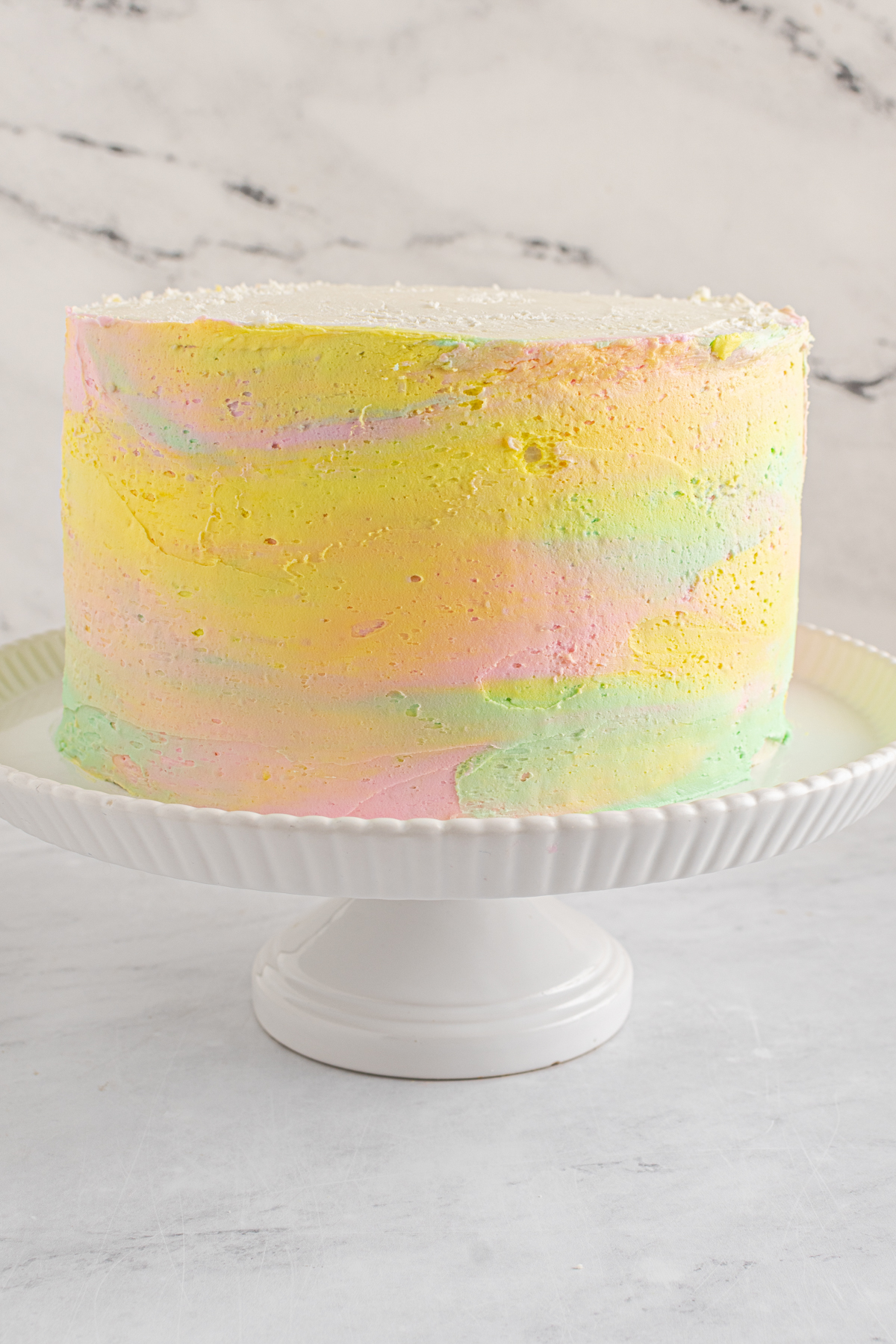 white cake with pastel colored frosting