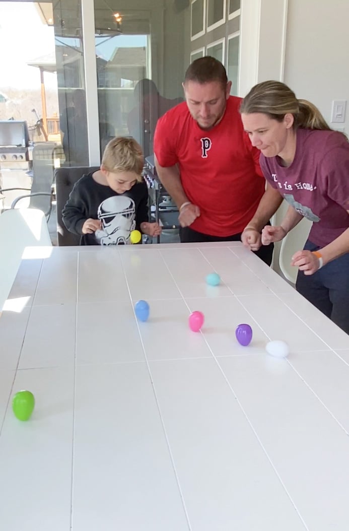 family watching spinning Easter eggs on a table