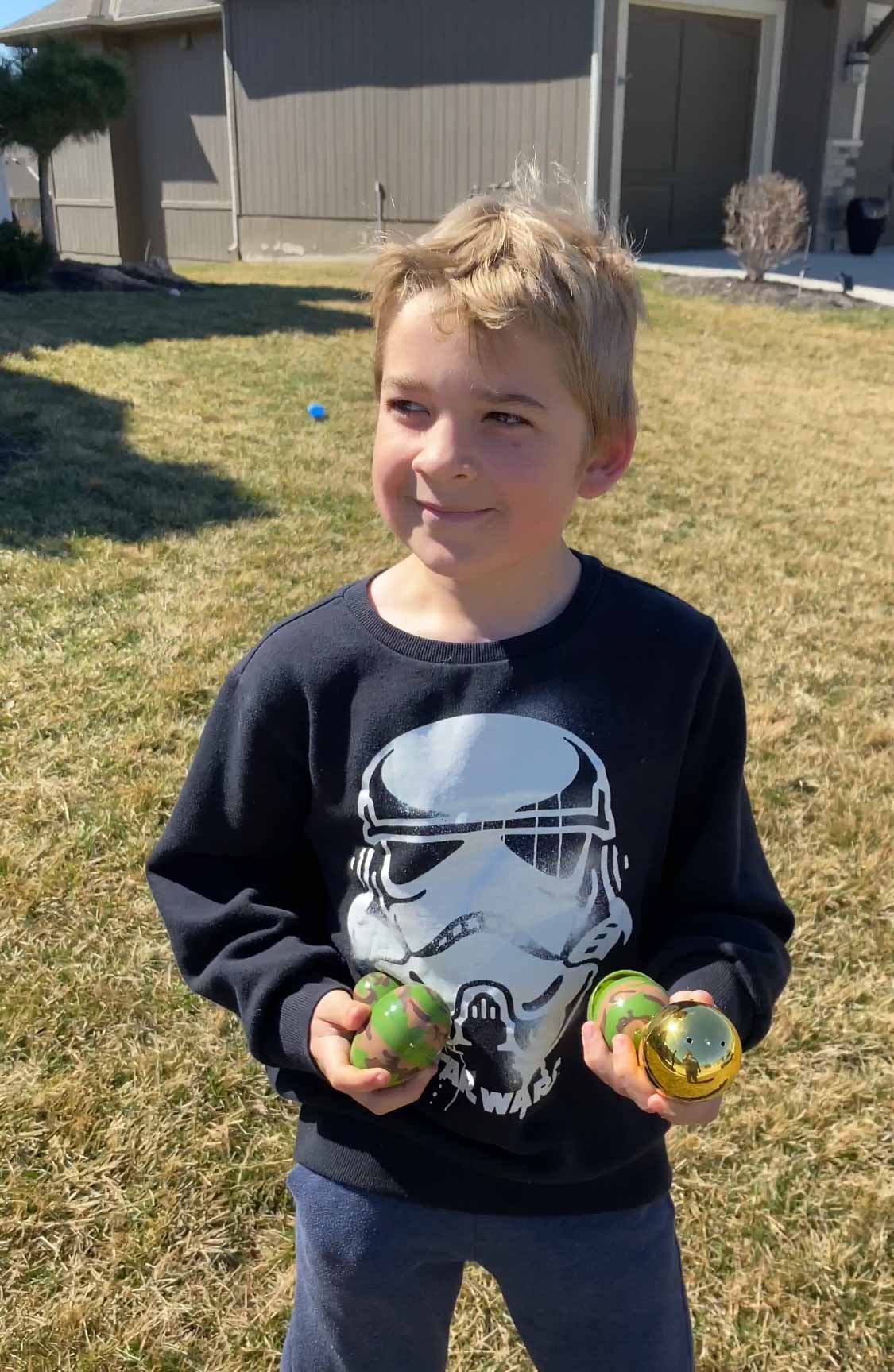 kid holding a golden egg