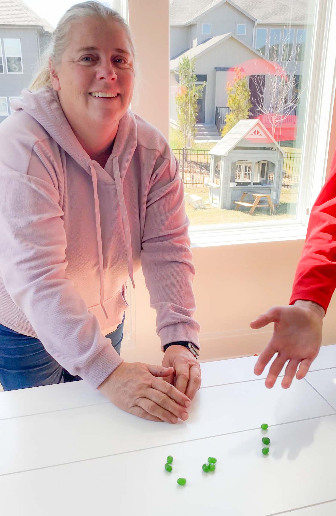 woman with green jelly beans in front of her