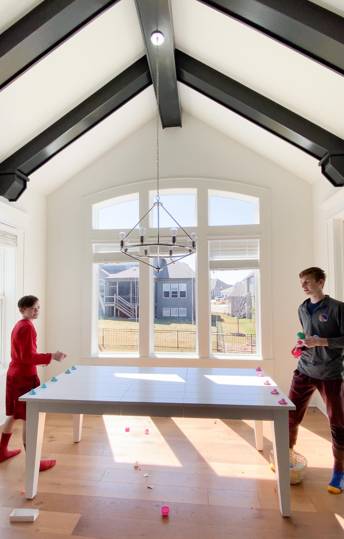 Two teens playing Easter games in a dining room