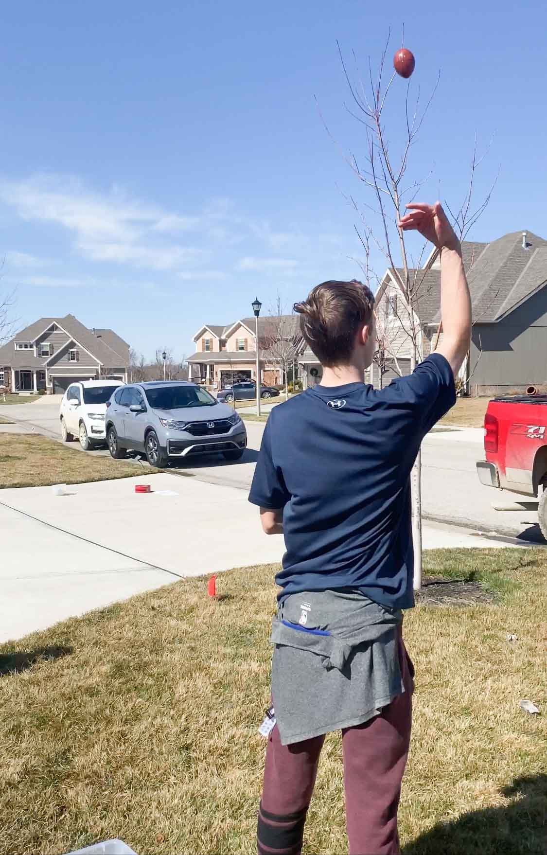 Teen tossing an egg over his head