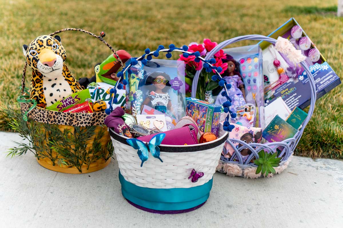 three Encanto Easter baskets on a driveway