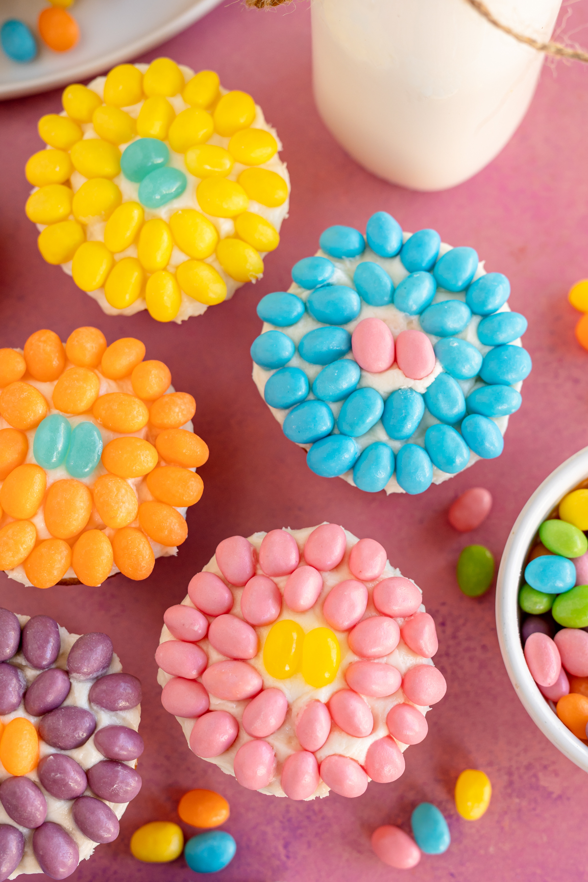 a bunch of flower cupcakes made using jelly beans