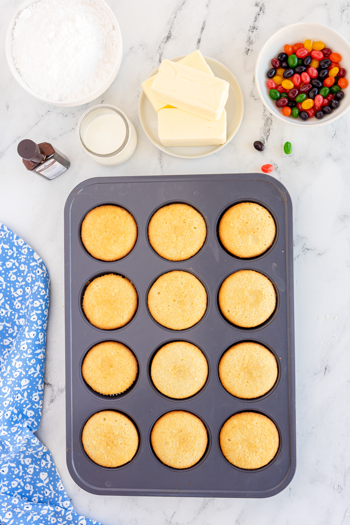 vanilla cupcakes cooling in a muffin tin
