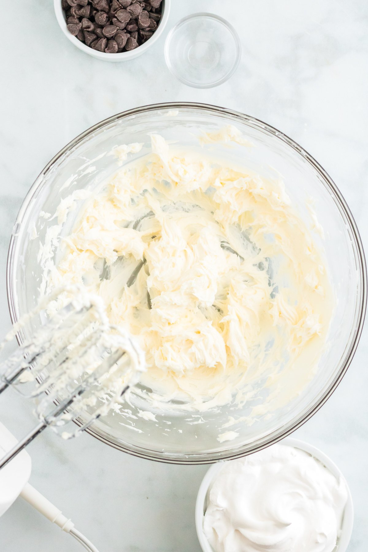 cream cheese mixed in a glass bowl
