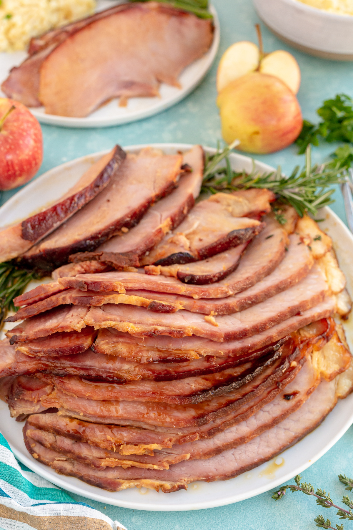 a sliced glazed ham on a plate