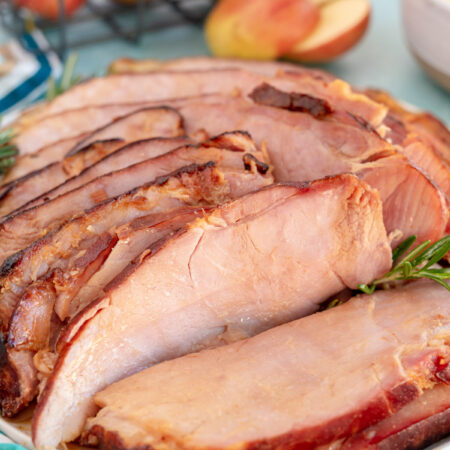 glazed ham sliced on a white plate