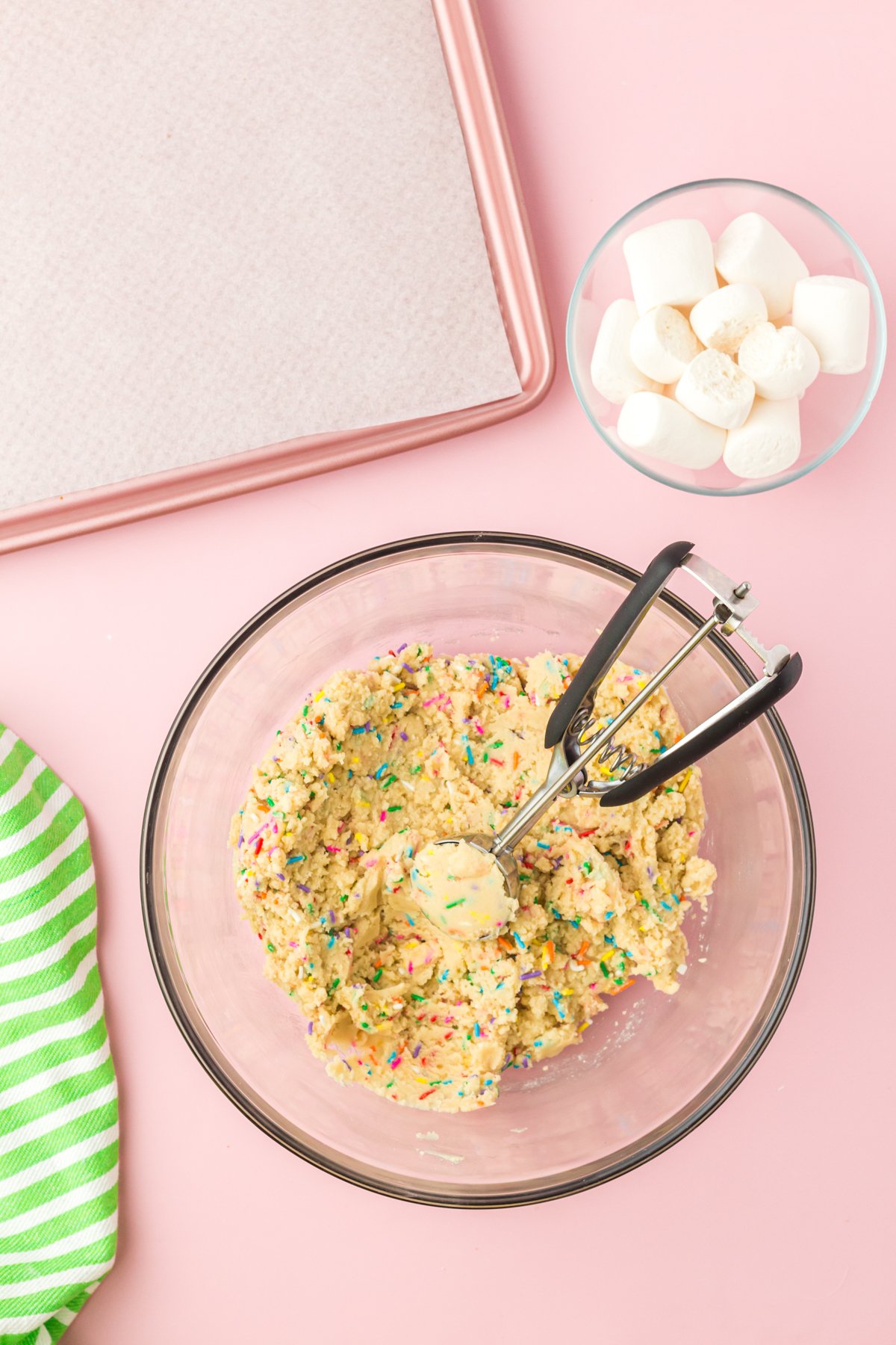 cookie scoop in a bowl with sprinkle cookie dough