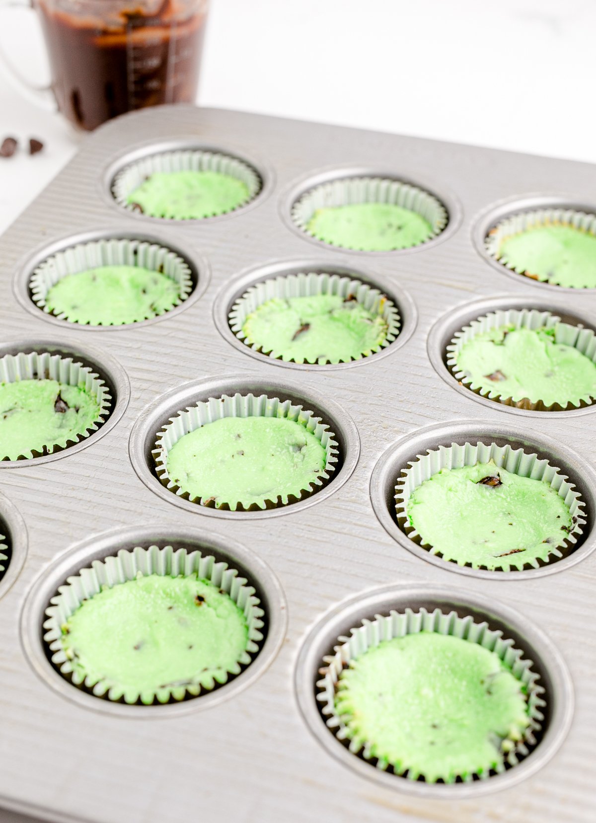 mint chcoolate cheesecake cooling in a muffin tin