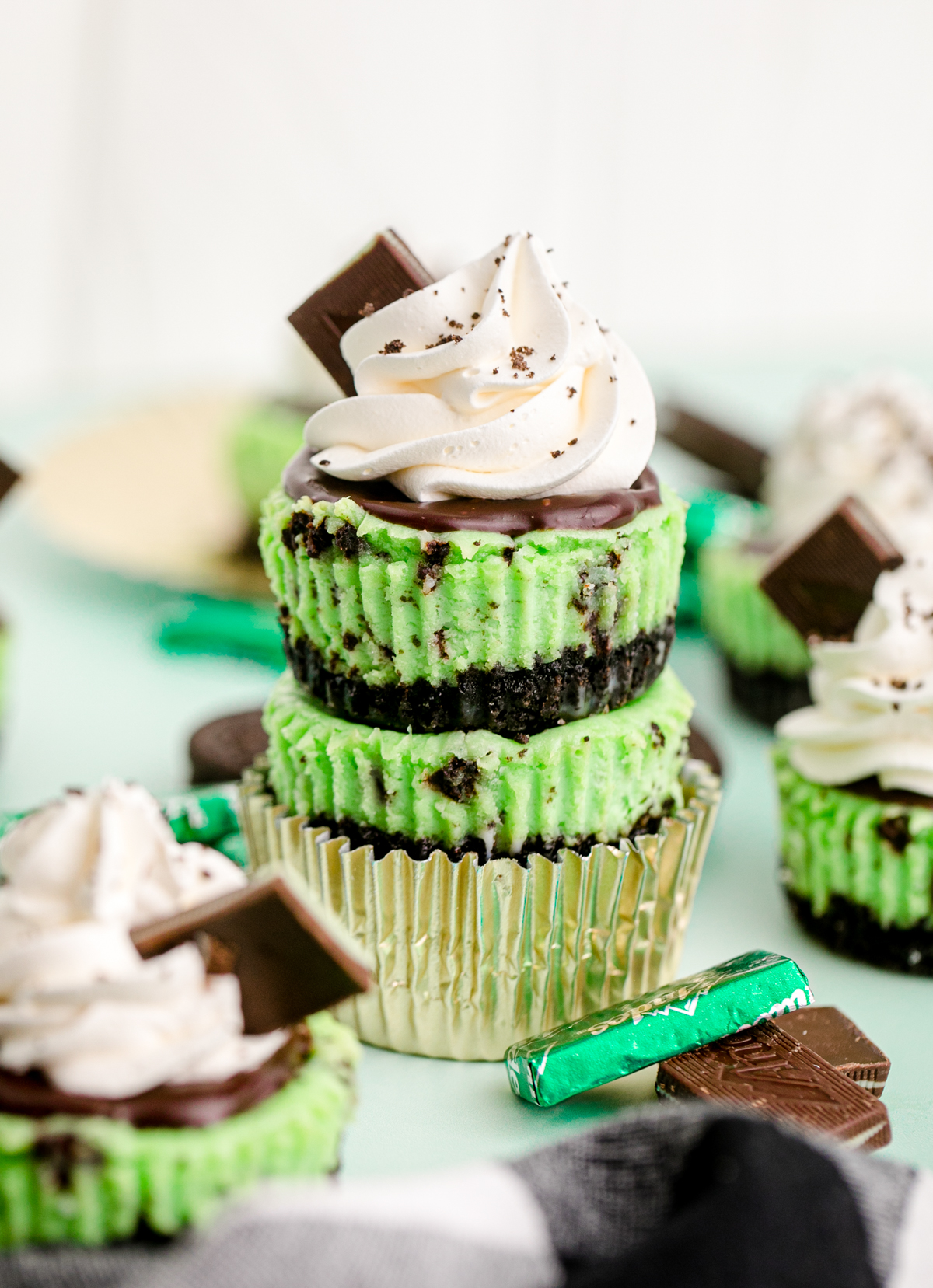 two mint chocolate cheesecake stacked on top of each other