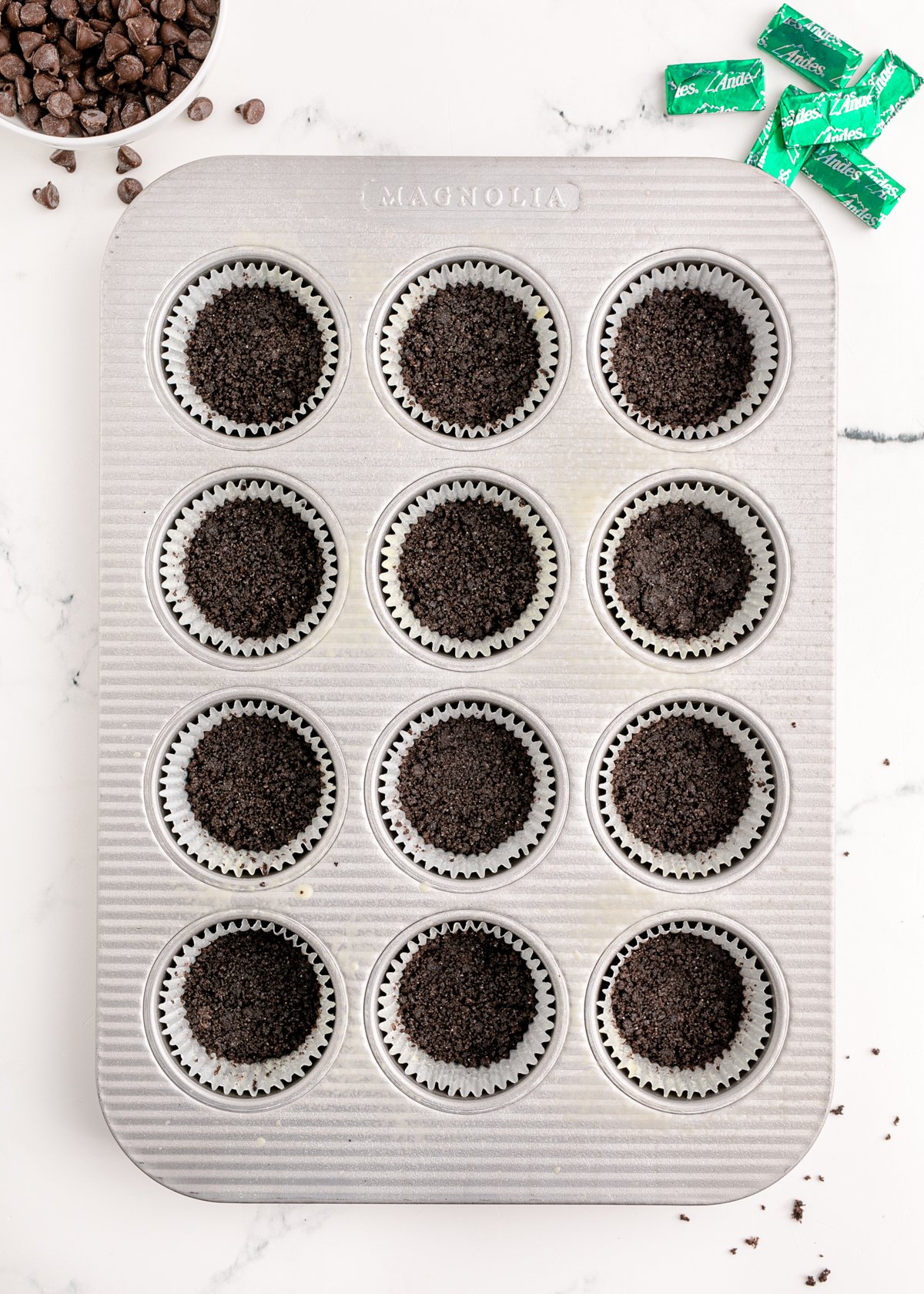 Oreo crumbs in a muffin tin