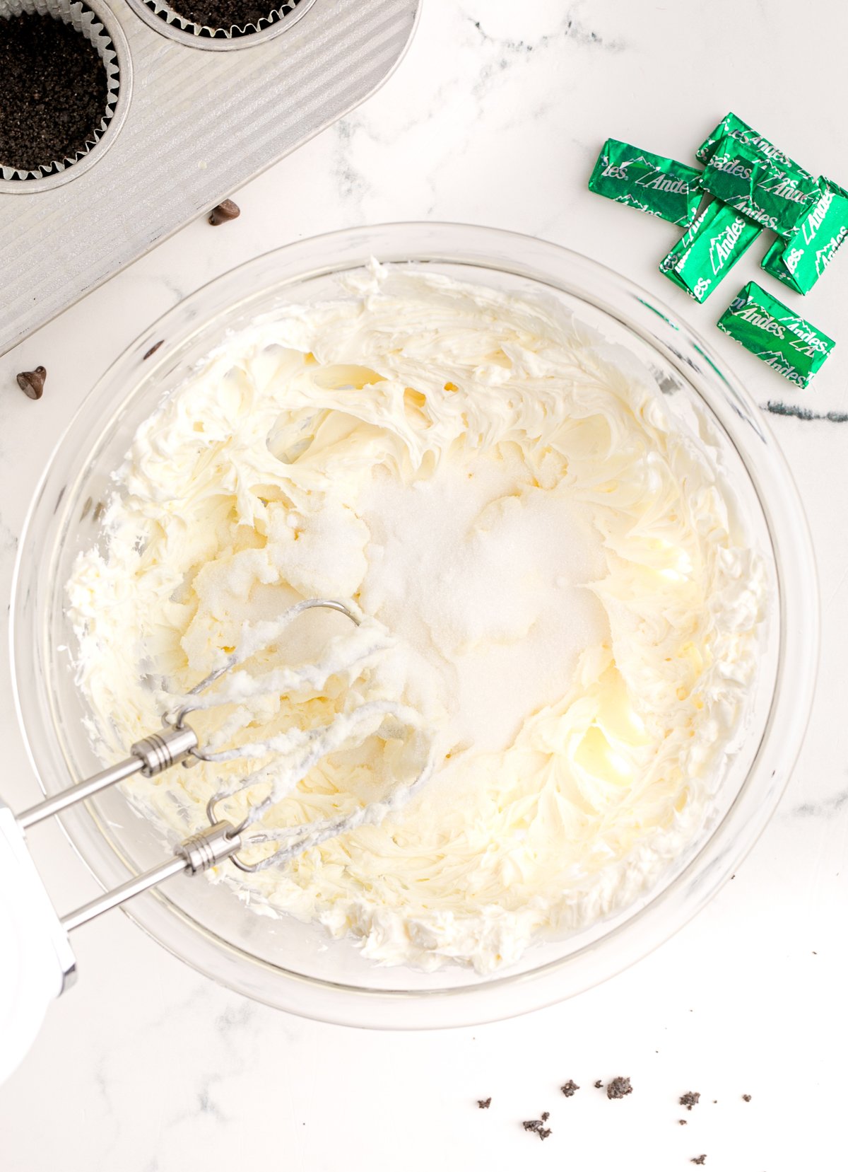 cream cheese and sugar in a glass bowl