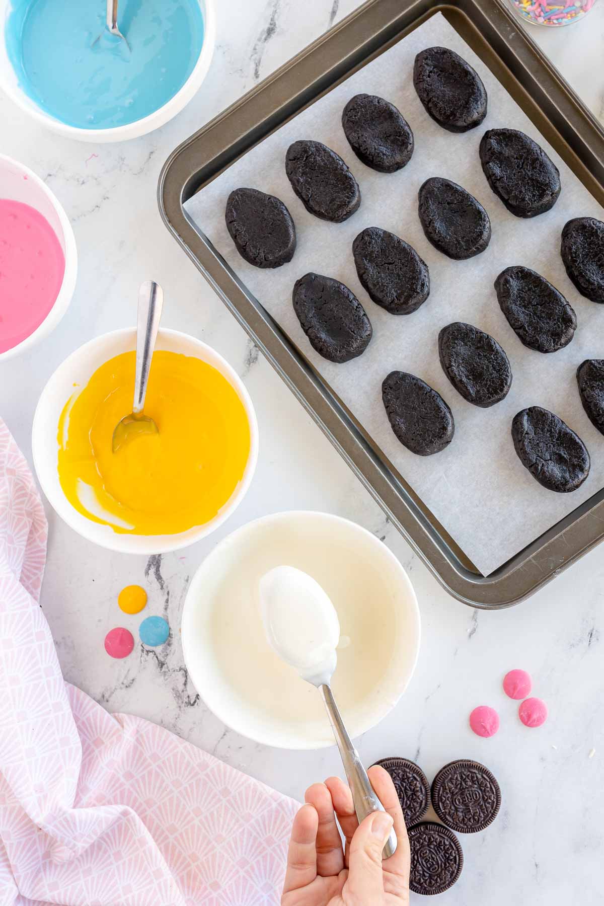 dipping Oreo Easter eggs into white chocolate