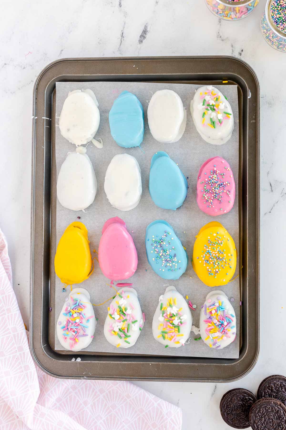 baking sheet full of decorated Oreo Easter eggs