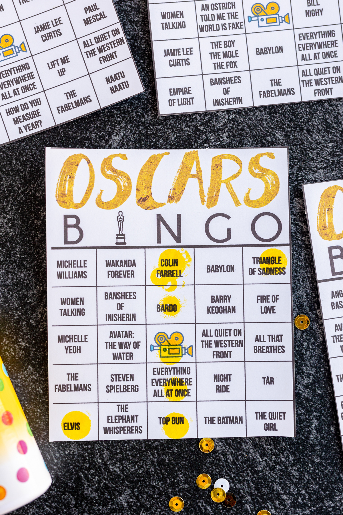 Oscar bingo printable with yellow bingo markers covering spaces