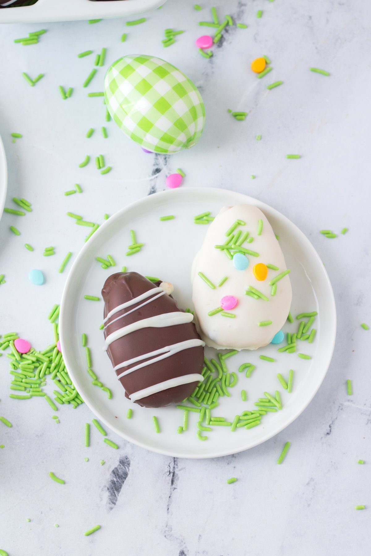 chocolate and white chocolate peanut butter eggs on a white plate