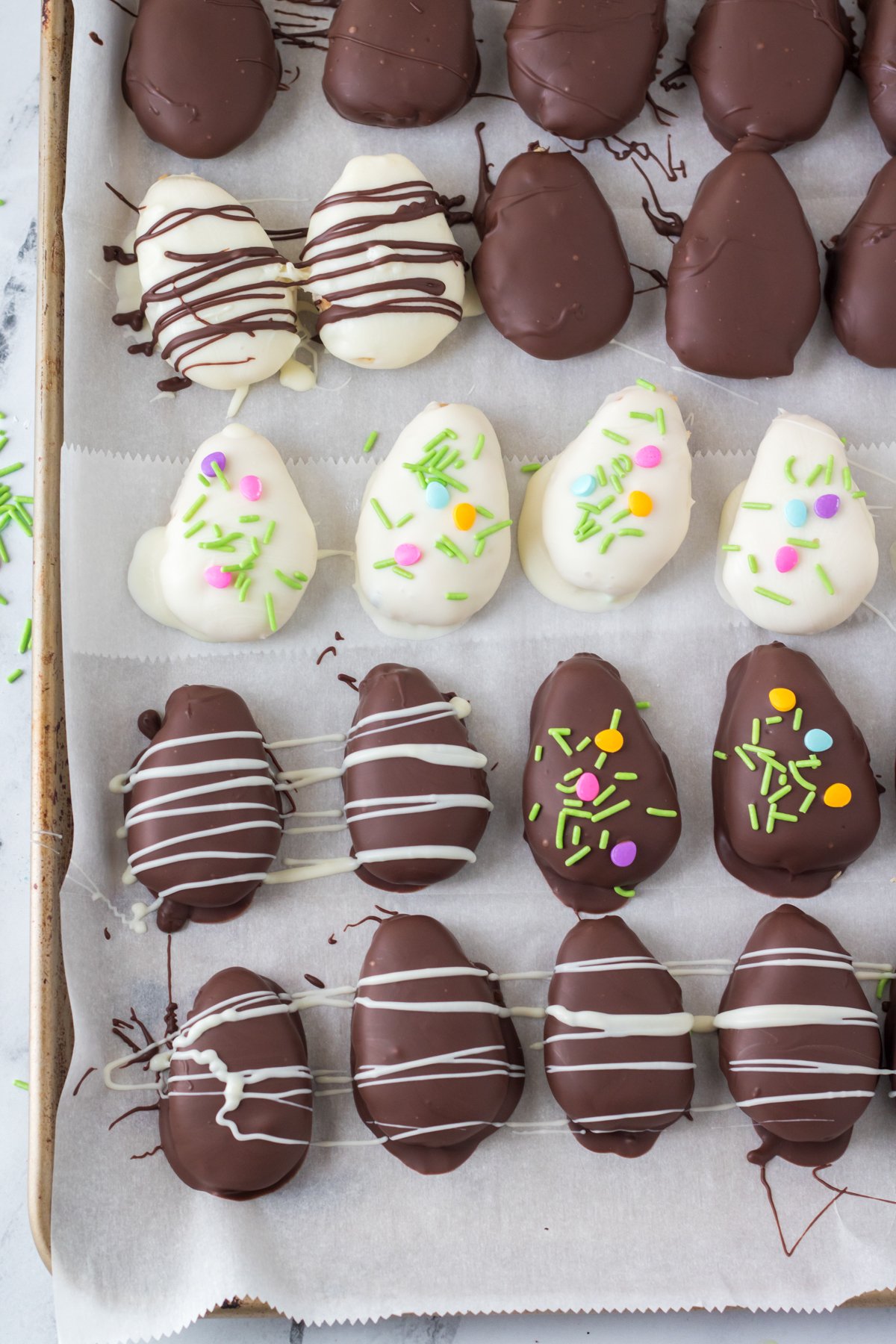 chocolate covered peanut butter eggs on a baking sheet