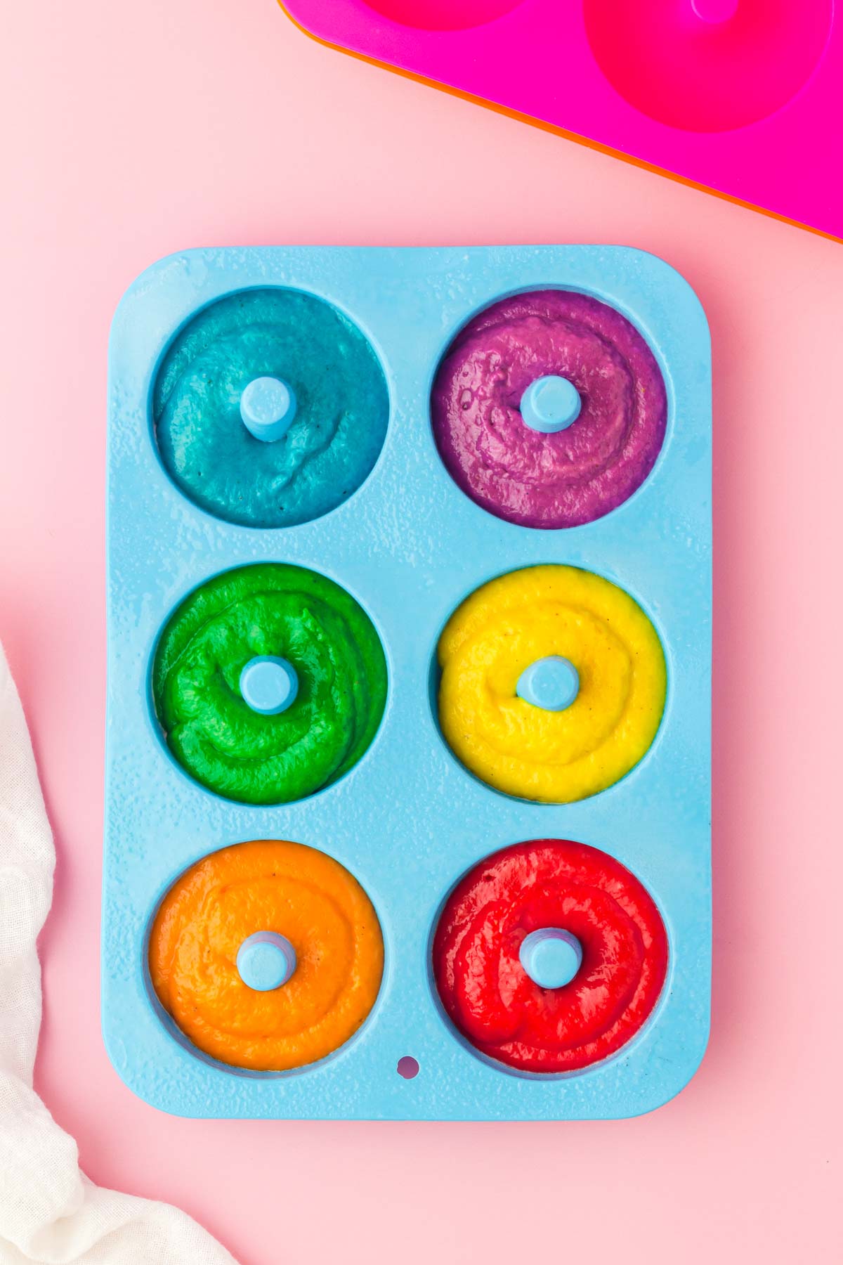 rainbow donuts in a cake pan
