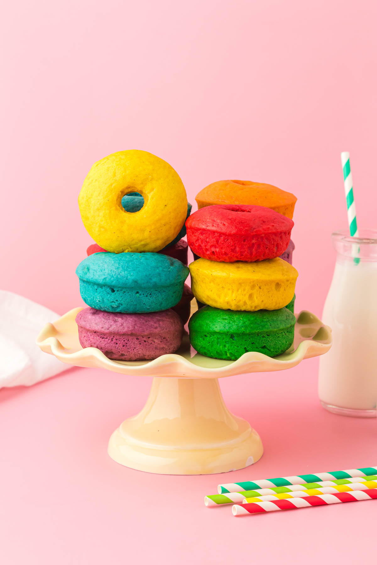rainbow donuts on a cake stand