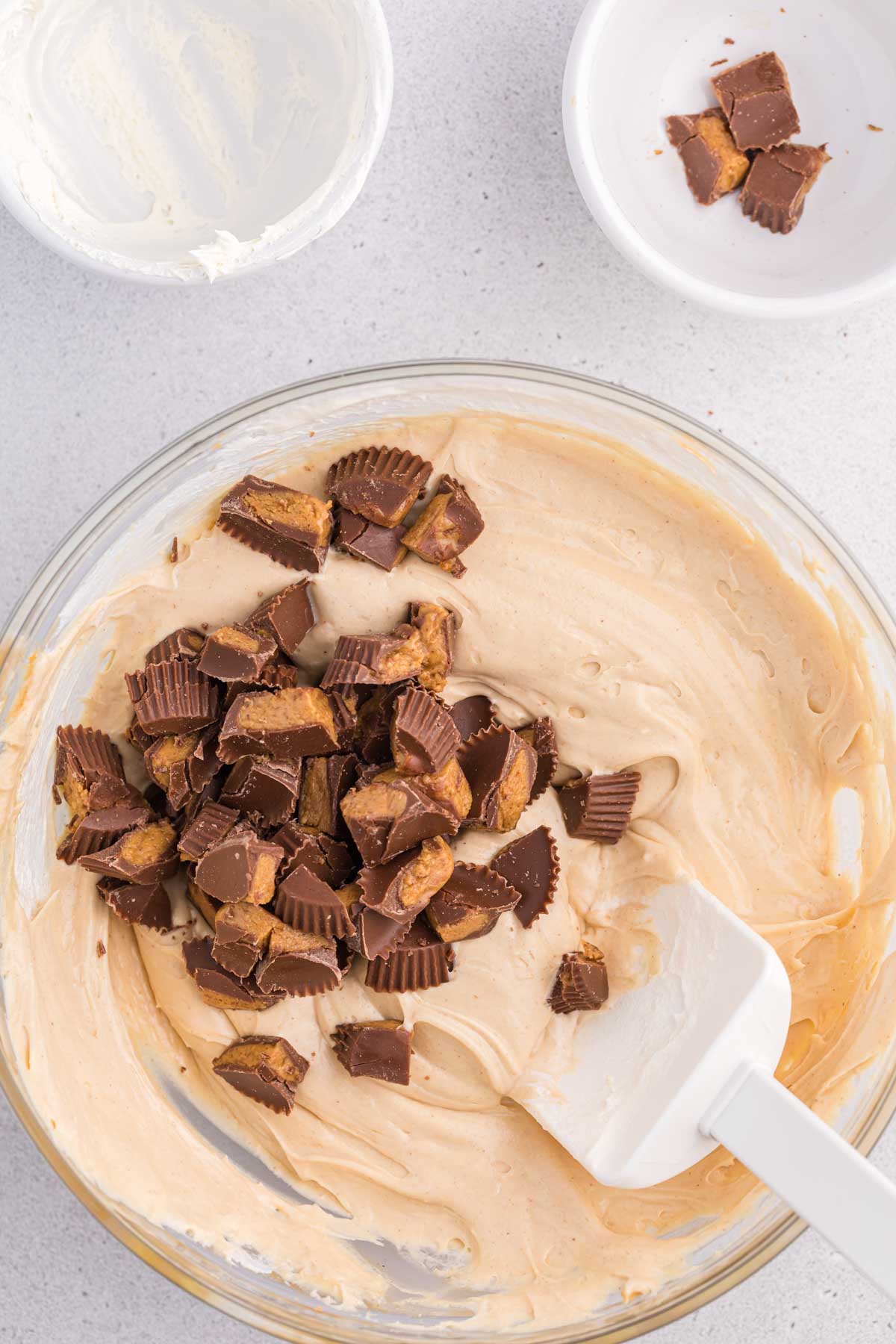 stirring peanut butter cups into a Reese's peanut butter dip