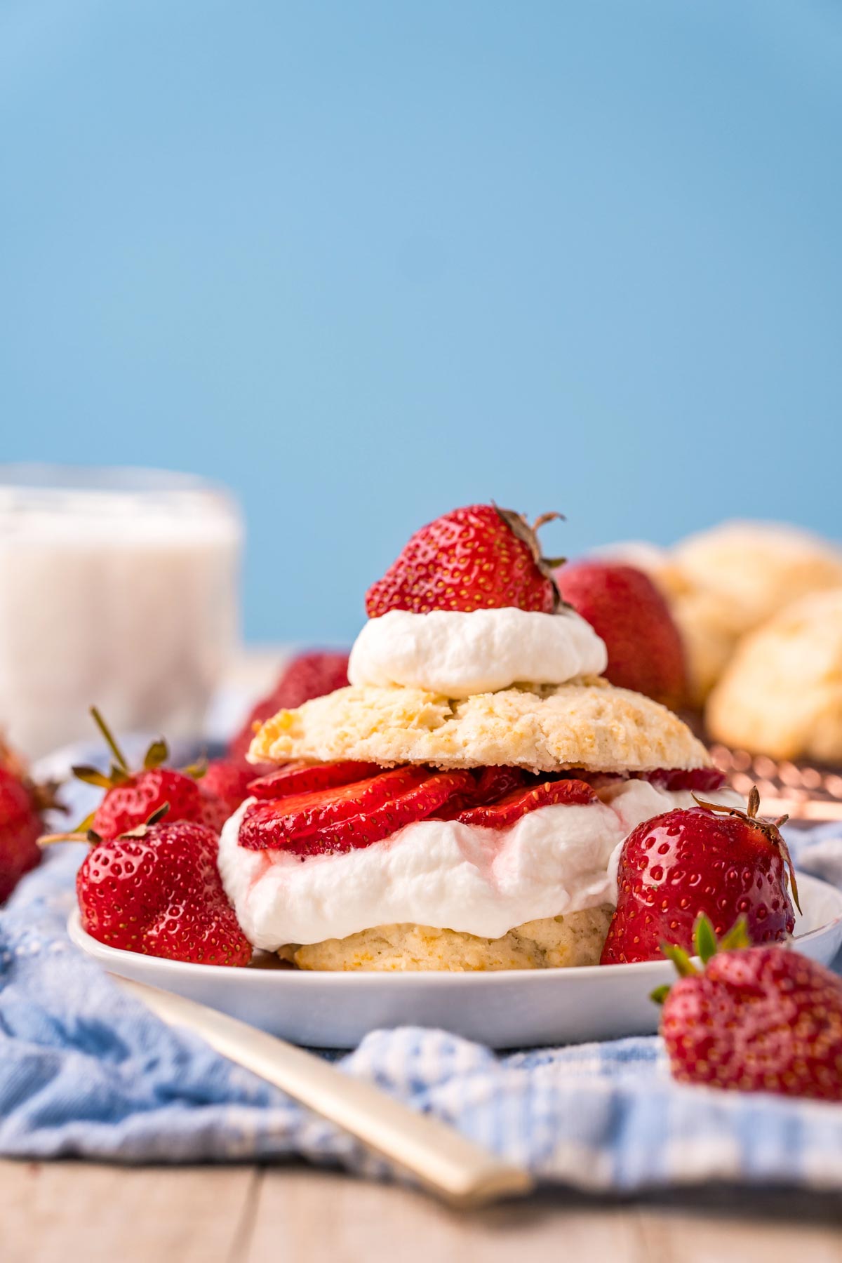 strawberry shortcake on a white plate with a blue napkin