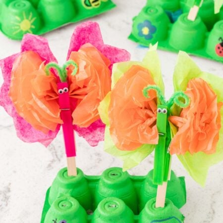 tissue paper butterflies on a green egg carton