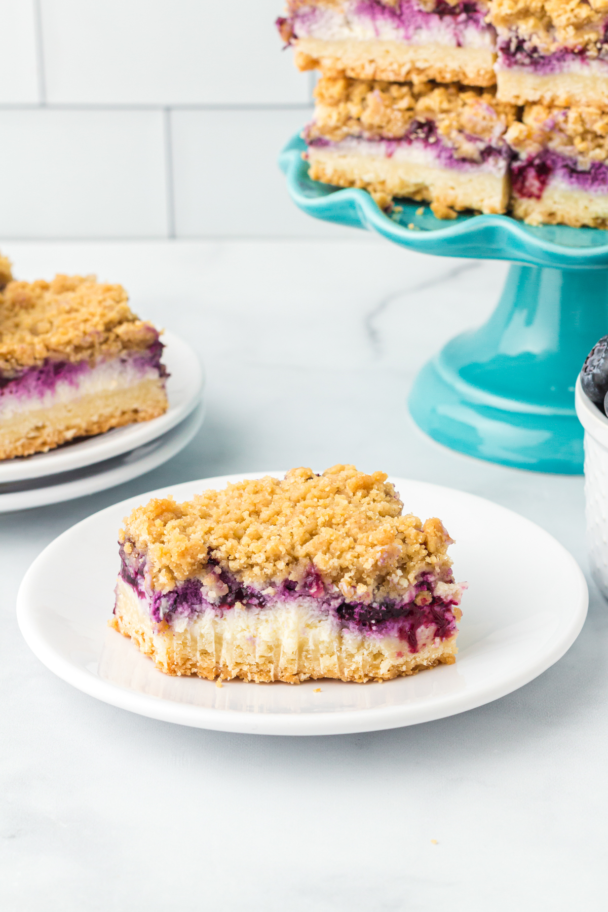 a blueberry cheesecake bar with a bite out of it