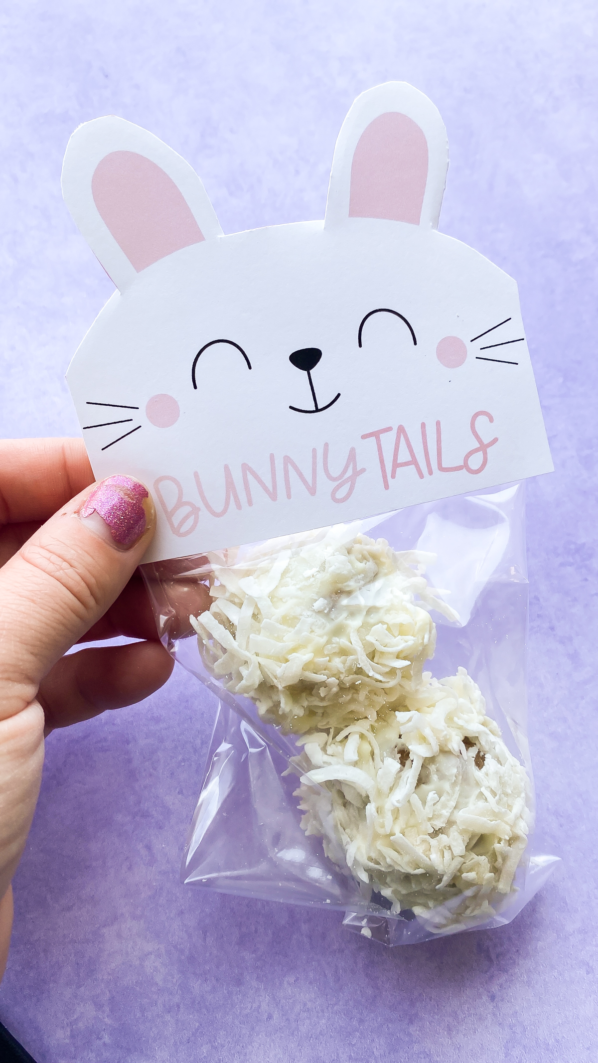 hand folding a bunny tail printable over a treat bag