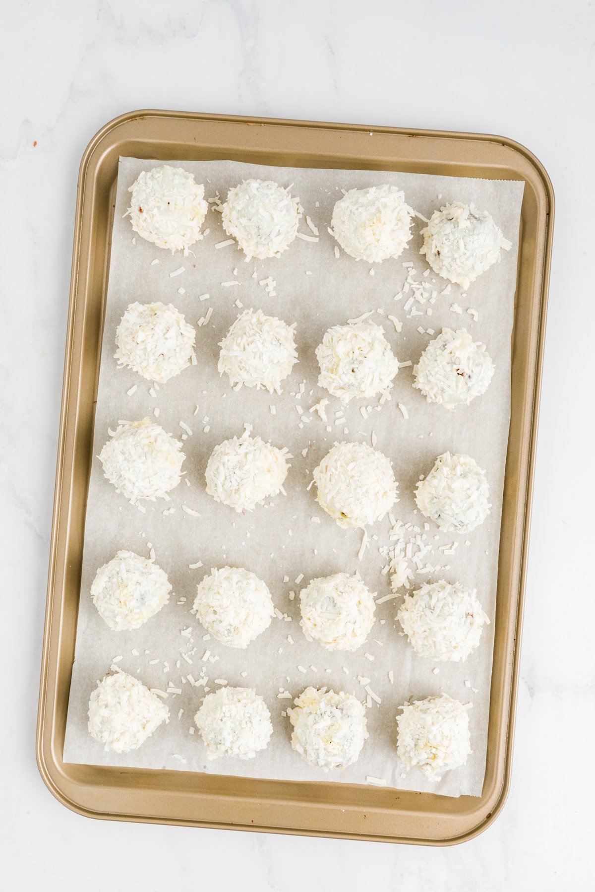 baking sheet with a bunch of carrot cake balls