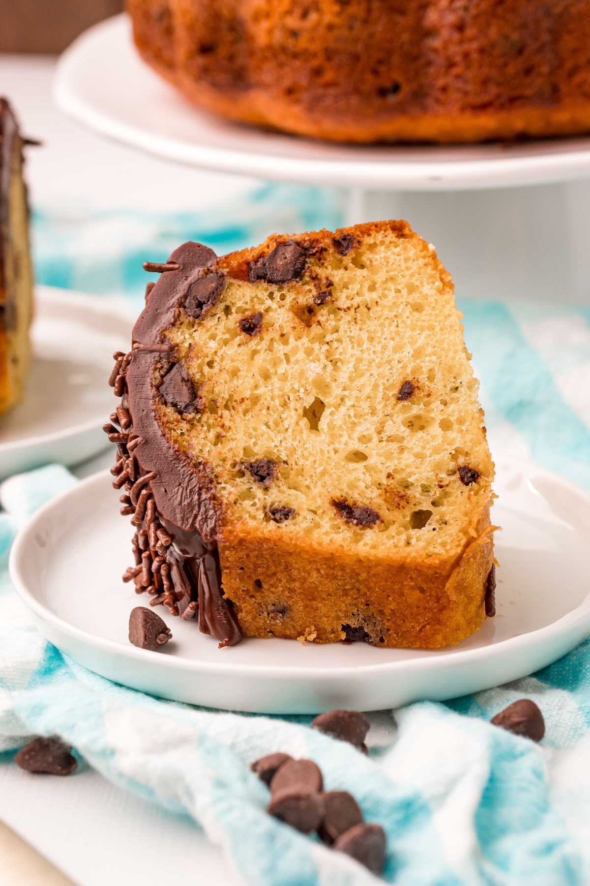 slice of chocolate chip bundt cake on a white plate