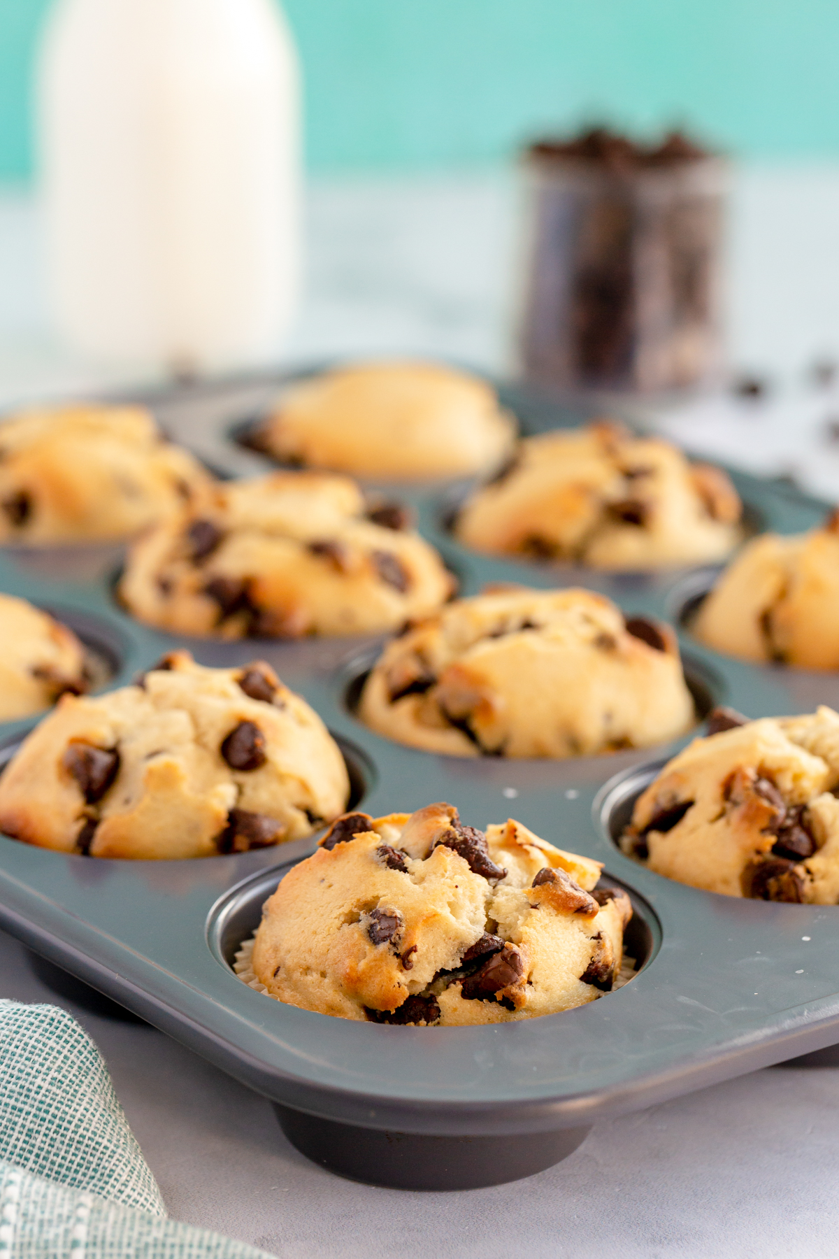 baked chocolate chip muffins in a muffin tin