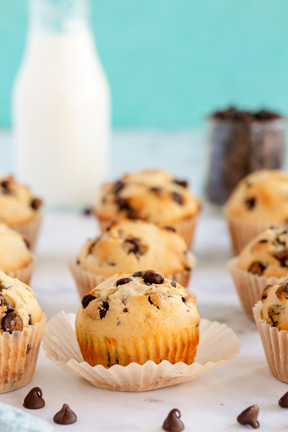 unwrapped chocolate chip muffins in a stack