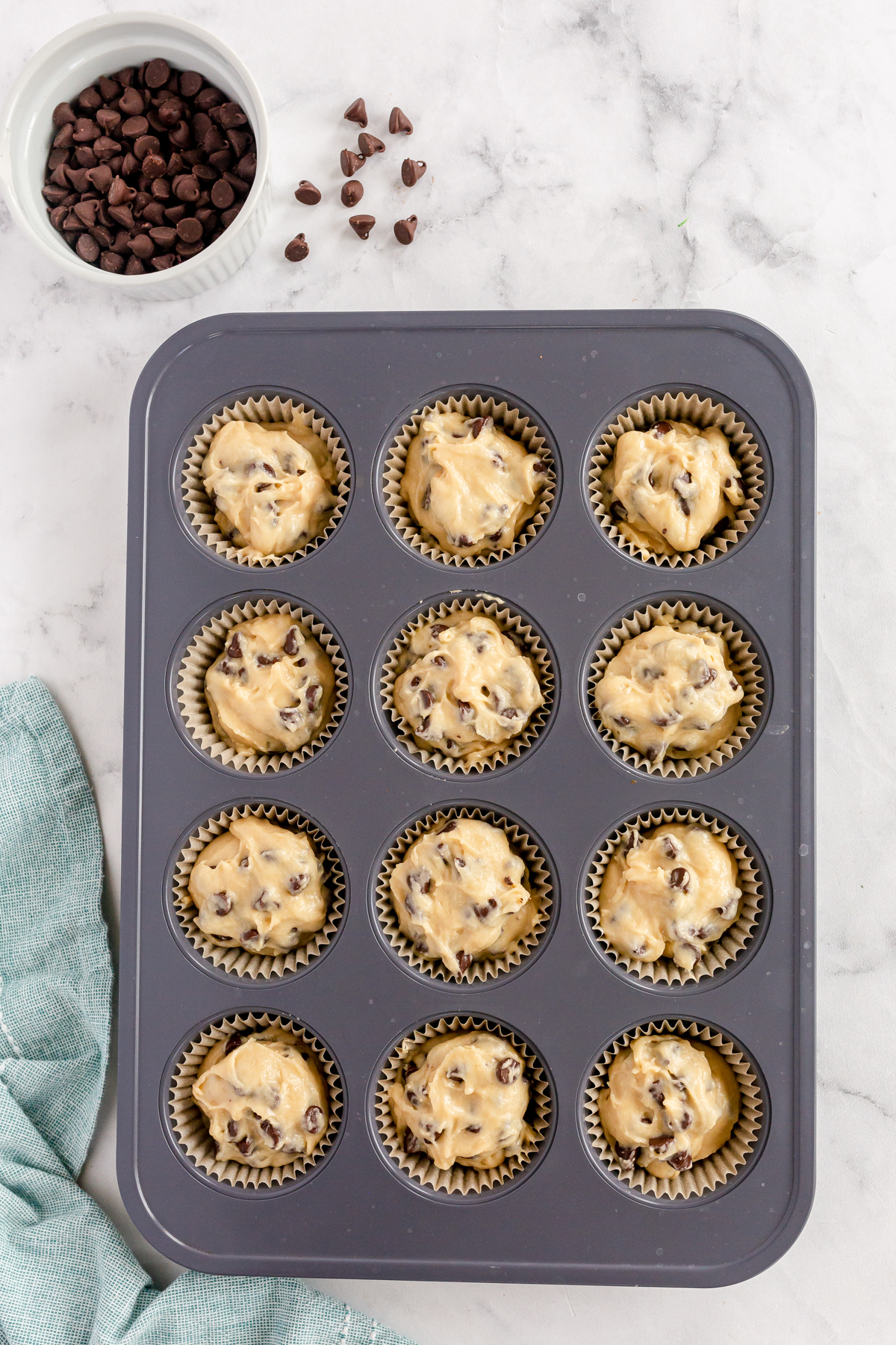 unbaked chocolate chip muffins in muffin tins