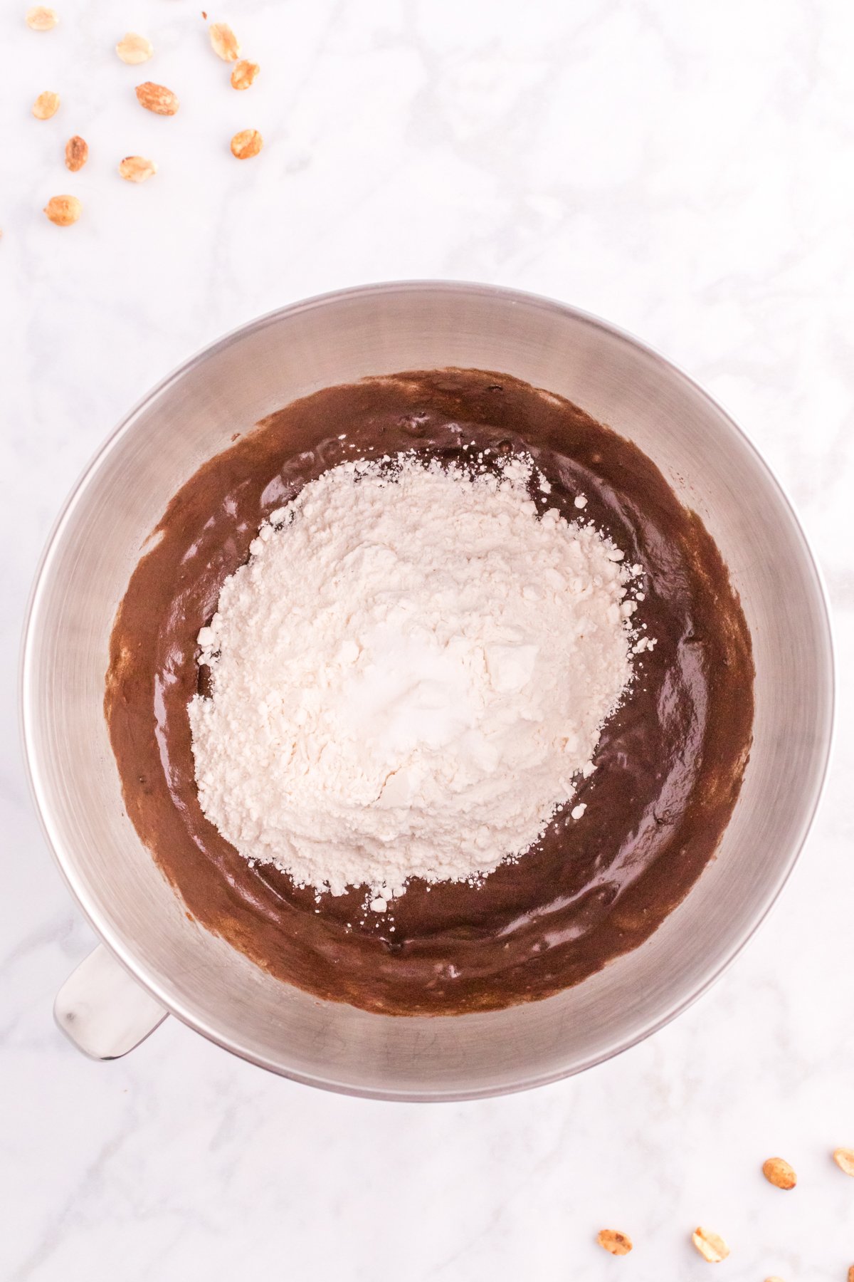 flour on top of chocolate brownie batter