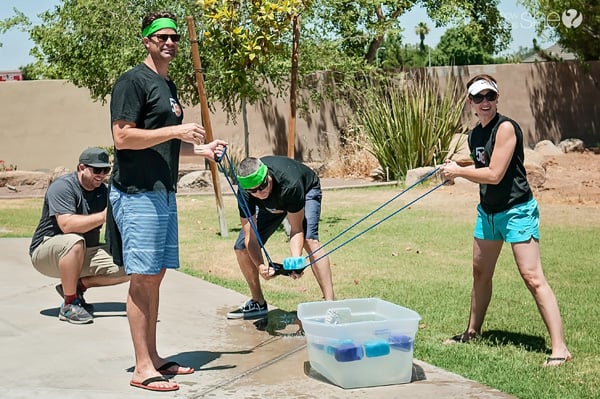 adults launching wet sponges