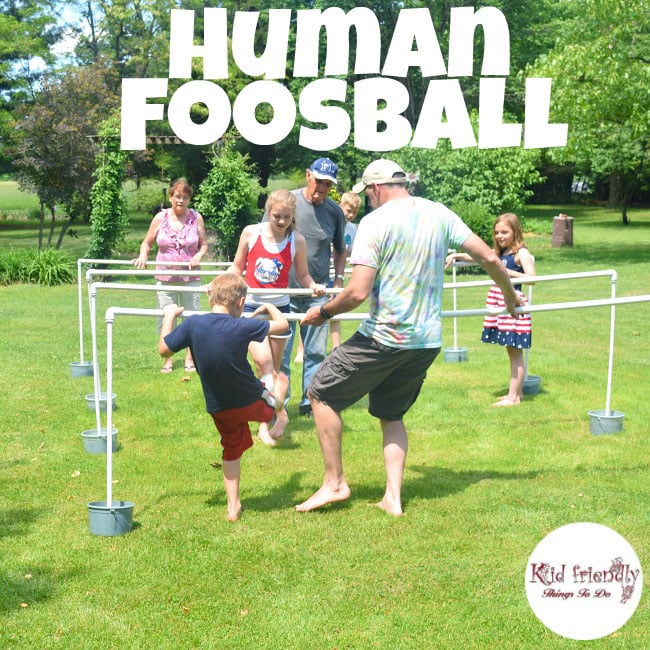family playing human foosball